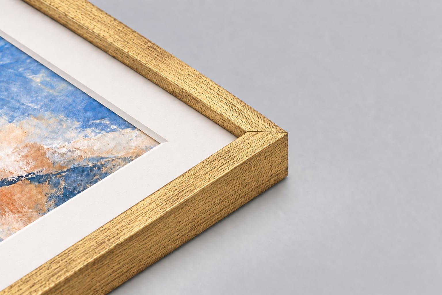 Corner of an antique gold frame showing the mitre and mount