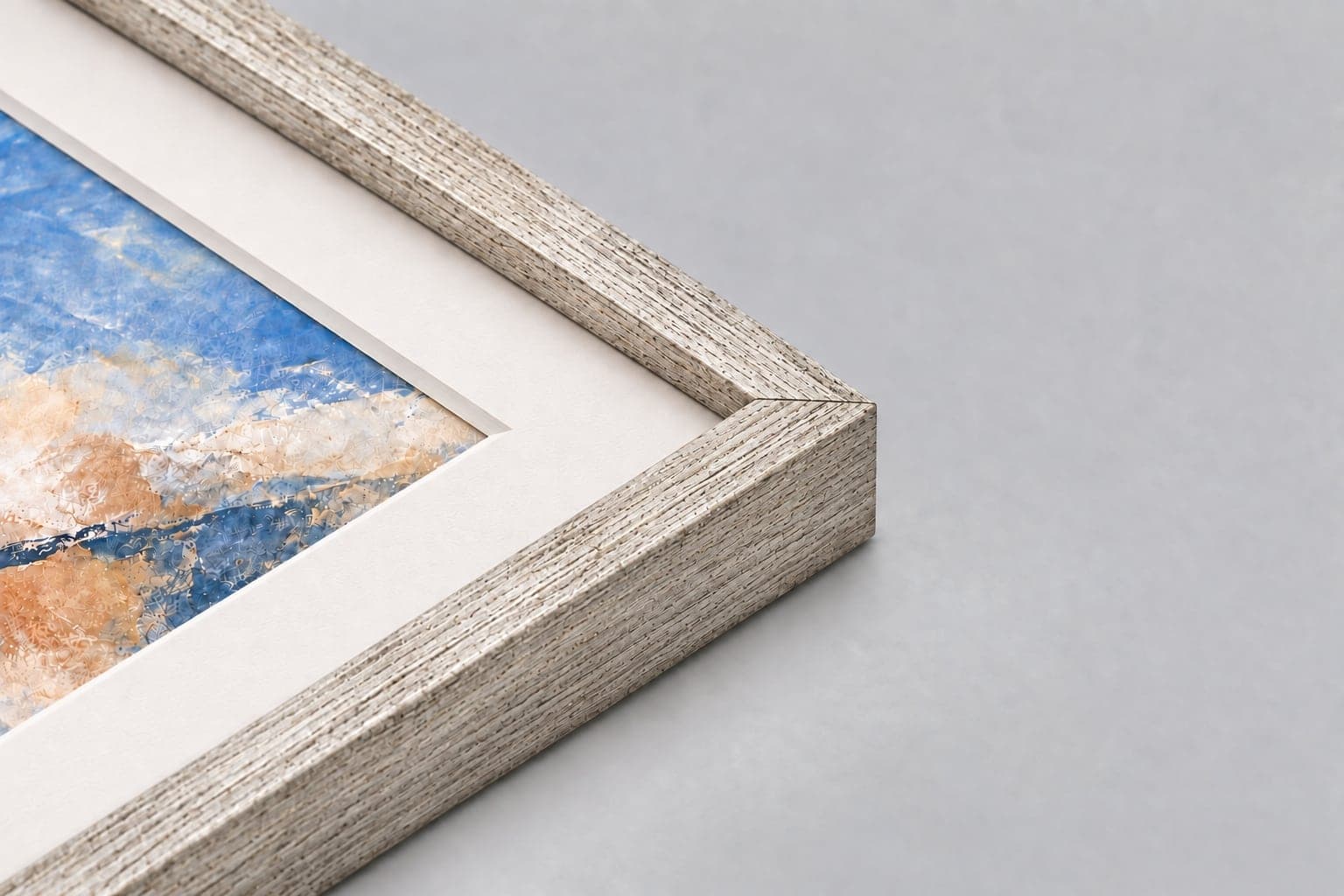Corner of an antique silver frame with a conservation mount