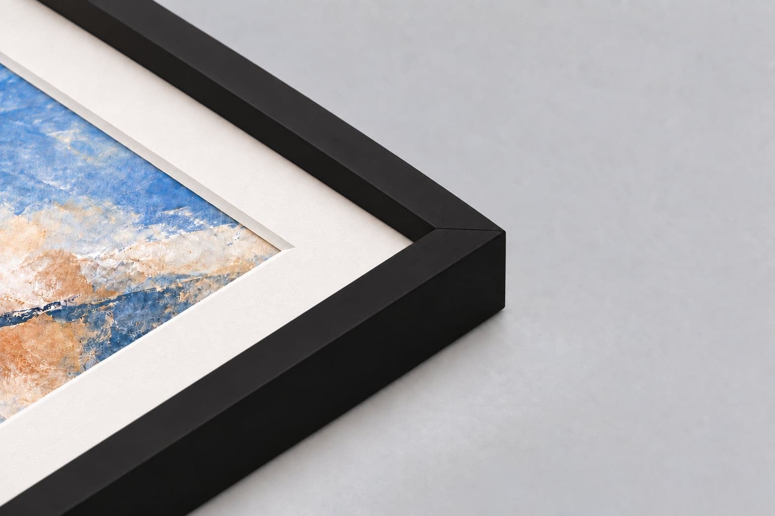 Corner detail of slim black frame with white mount